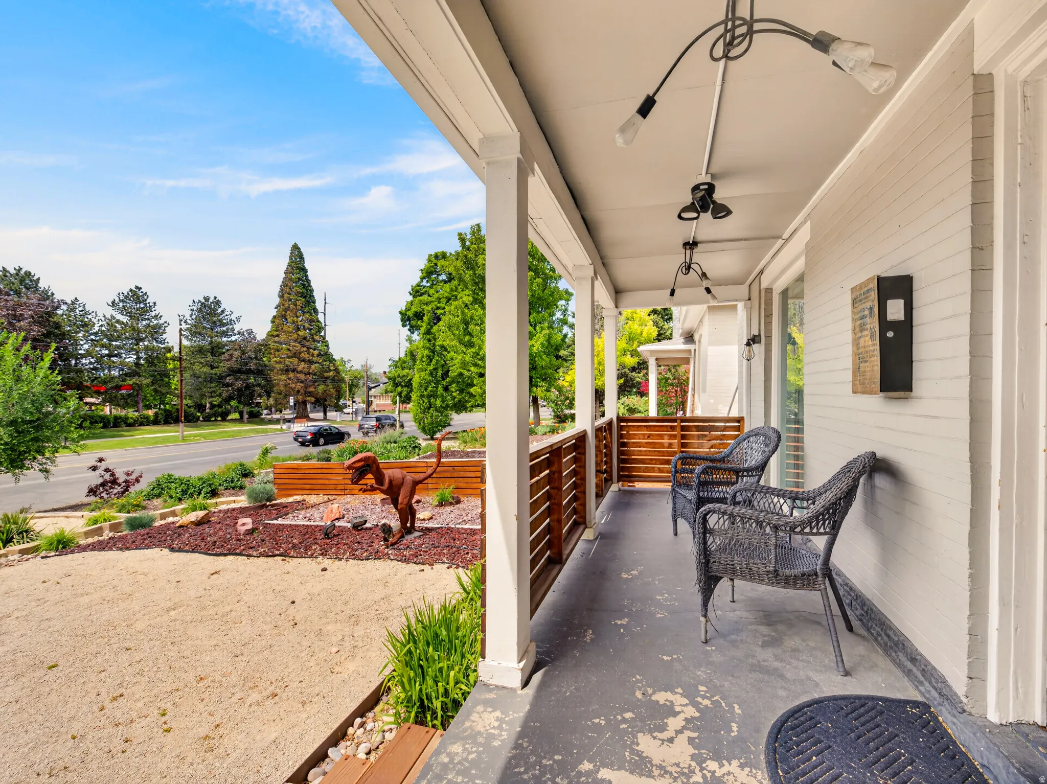 Covered porch with white columns and a wood-slat railing