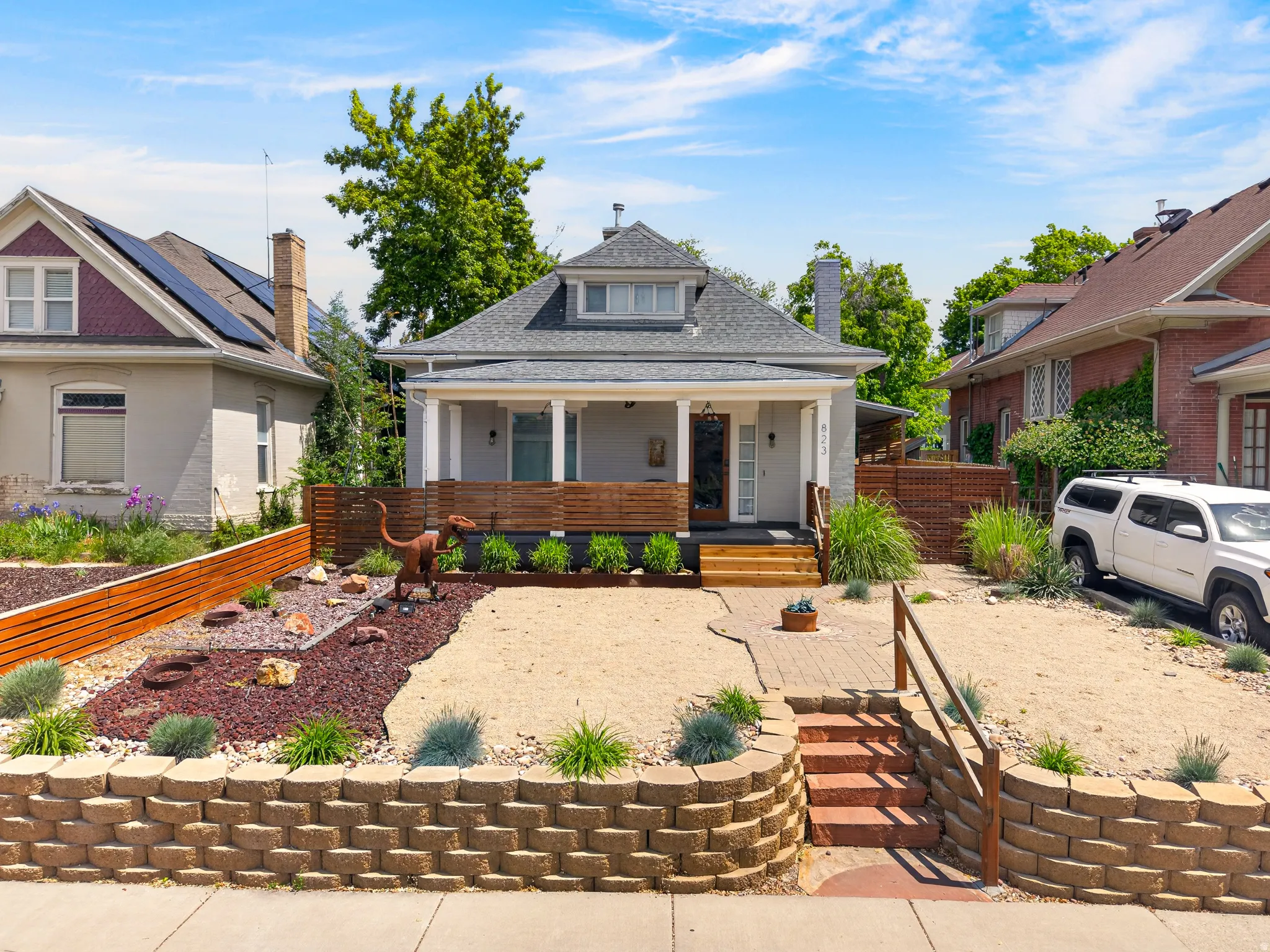 Light gray exterior with white columns and a dark gray roof