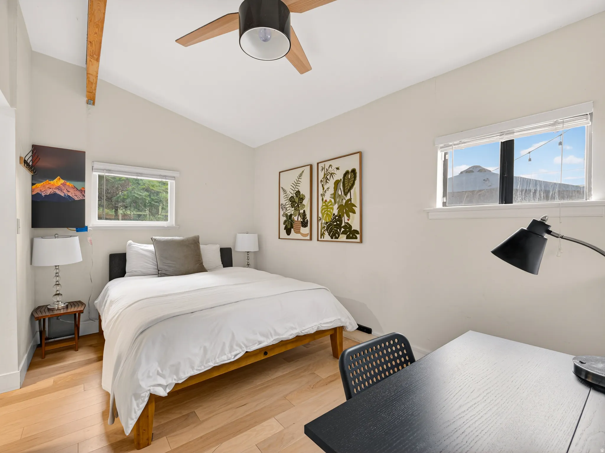 Vaulted ceiling with exposed wood beam and ceiling fan