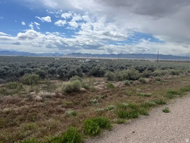 Expansive lot featuring natural sagebrush landscaping and distant mountain ranges