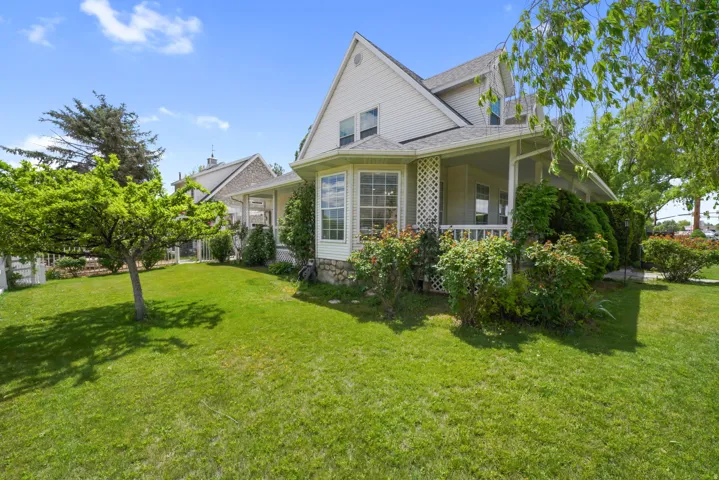 Expansive front yard with a manicured lawn and mature trees