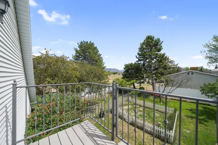 Balcony featuring composite decking and a gray metal railing
