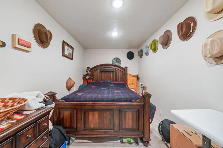 Bedroom featuring light-toned walls, recessed lighting, and wood-finish flooring