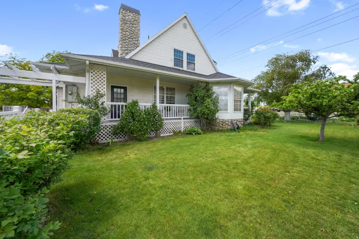 Expansive green lawn with mature trees and established landscaping