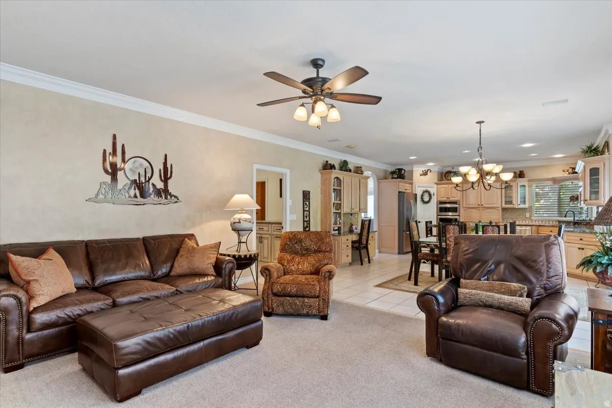 Open-concept living area featuring neutral walls and crown molding