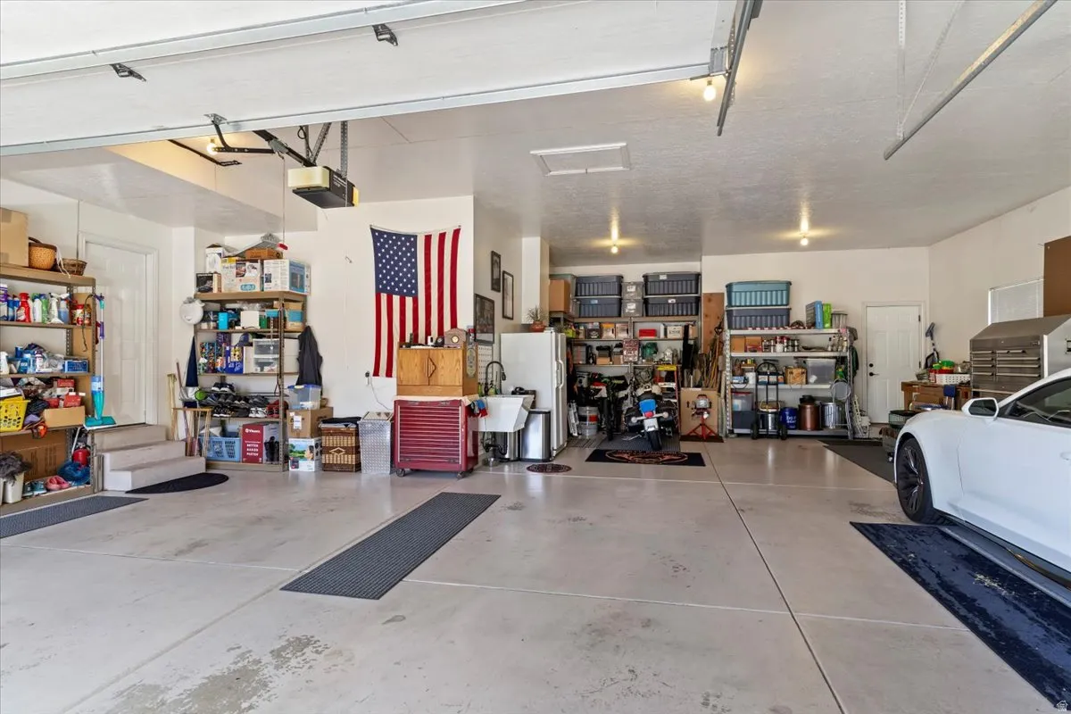 Spacious garage featuring concrete flooring and two garage door openers
