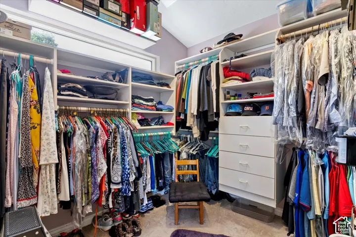 Custom closet system featuring multiple hanging rods, integrated shelving, and built-in drawers