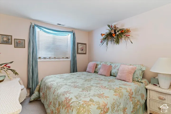 Carpeted room with a horizontal window featuring blinds and light-colored walls