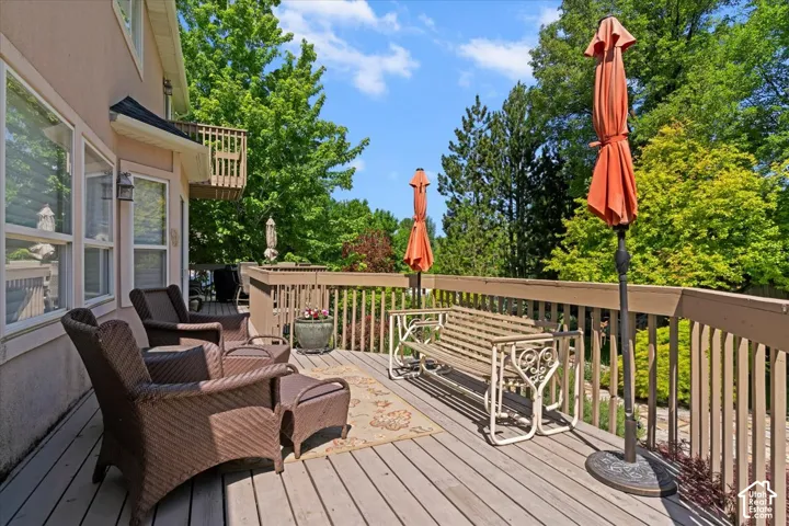 Spacious outdoor deck featuring wood-finish decking and perimeter railings