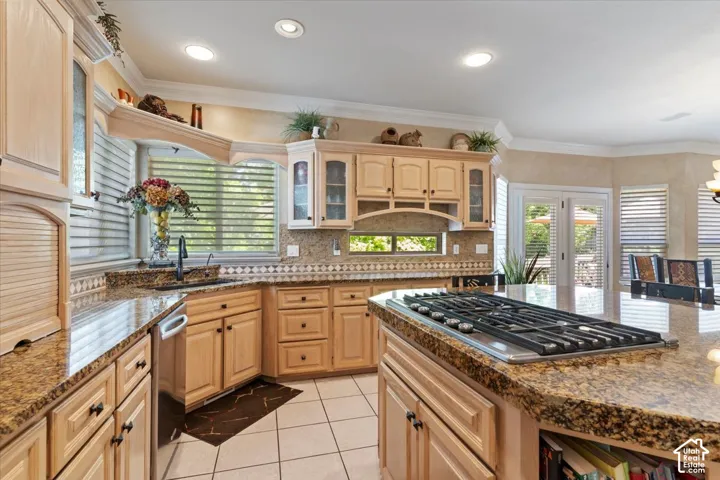Kitchen featuring light wood cabinetry, granite countertops, tile flooring, recessed lighting, and a built-in gas cooktop on the island