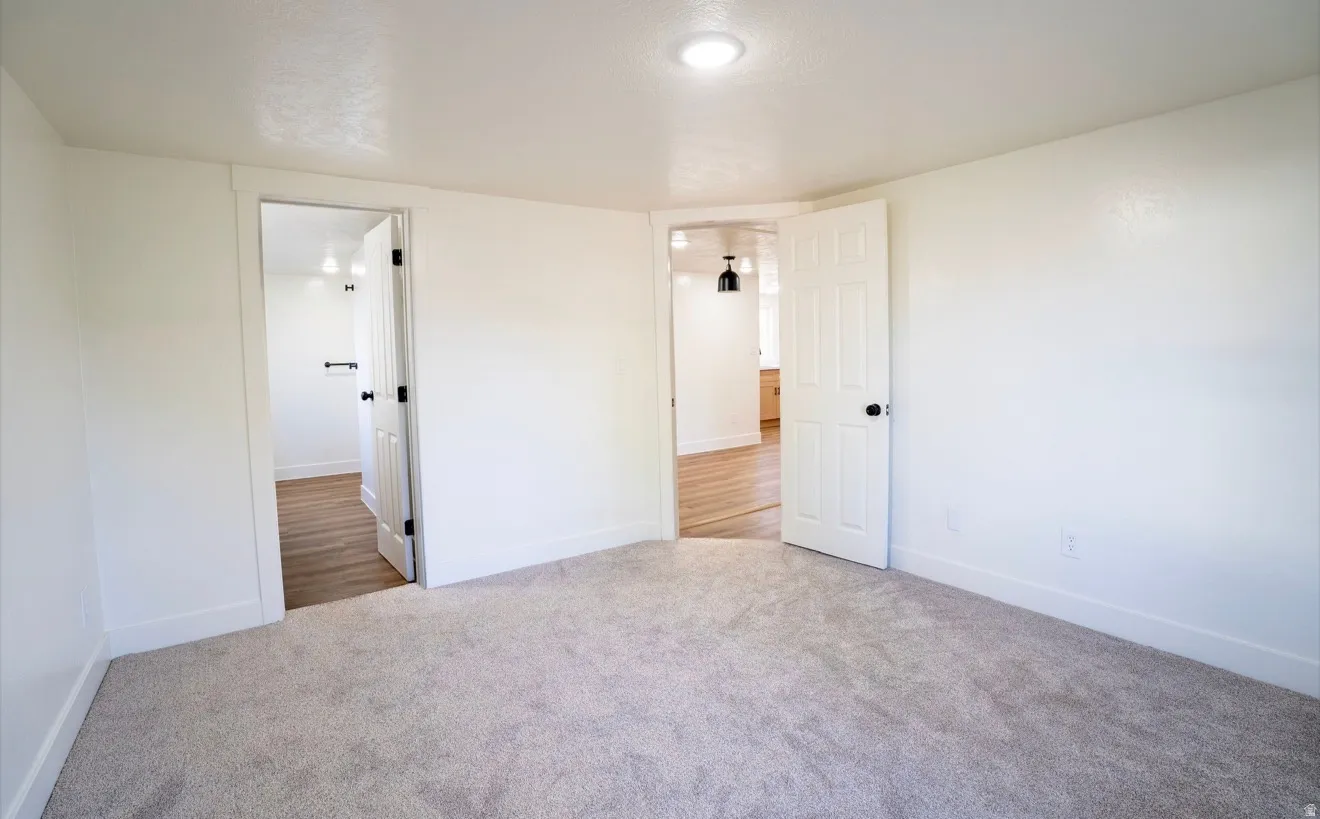 Interior room featuring light-colored carpeting and white walls
