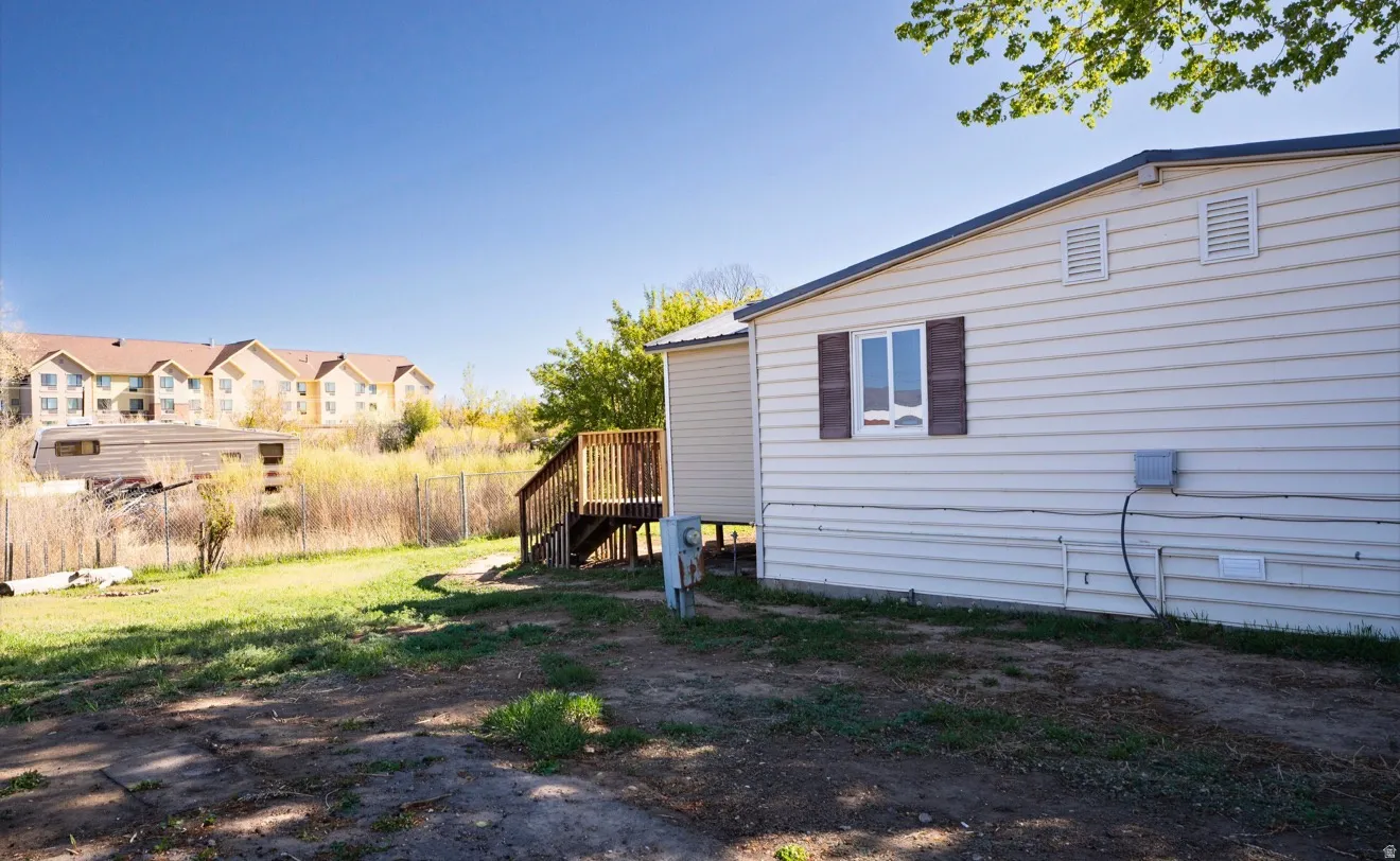 Exterior featuring horizontal siding, a window with decorative shutters, and an outdoor utility connection