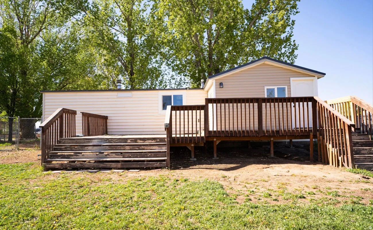 Multi-level wood deck featuring railings and stairs