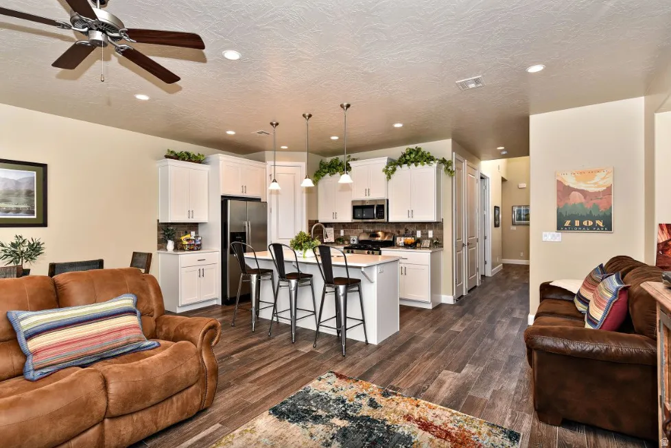 Open-concept living area featuring wood-finish flooring, recessed lighting, and a ceiling fan
