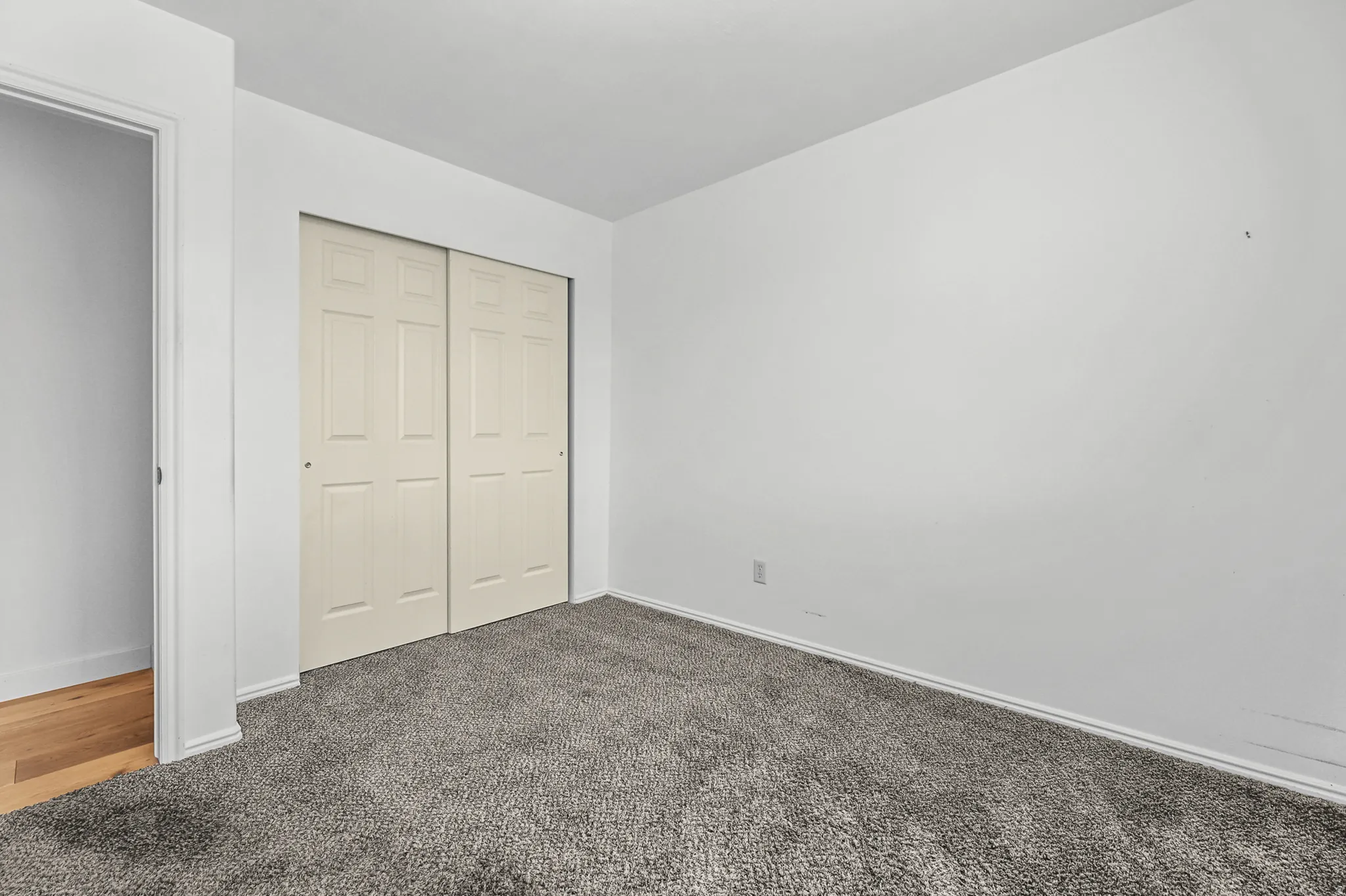 Room featuring gray carpet flooring and white walls