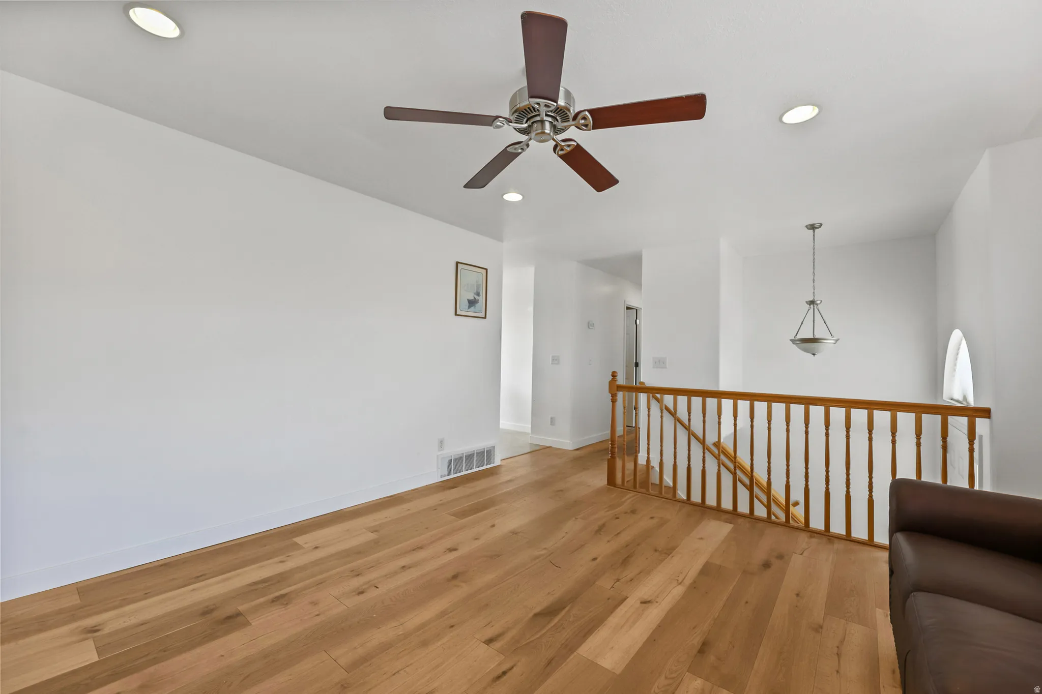 Spacious interior featuring wood-finish flooring, recessed lighting, and a contemporary ceiling fan