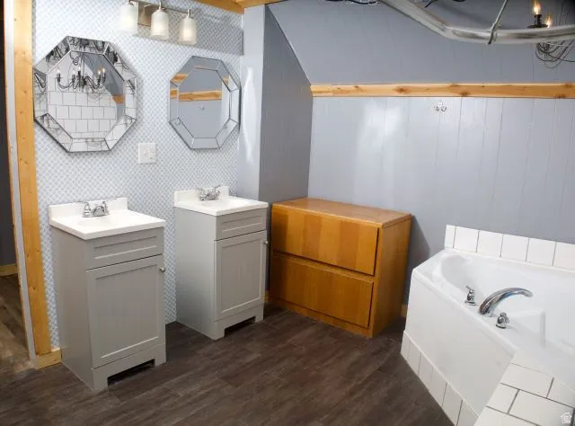Bathroom featuring dual vanity sinks with white countertops, octagonal framed mirrors, and a three-light fixture