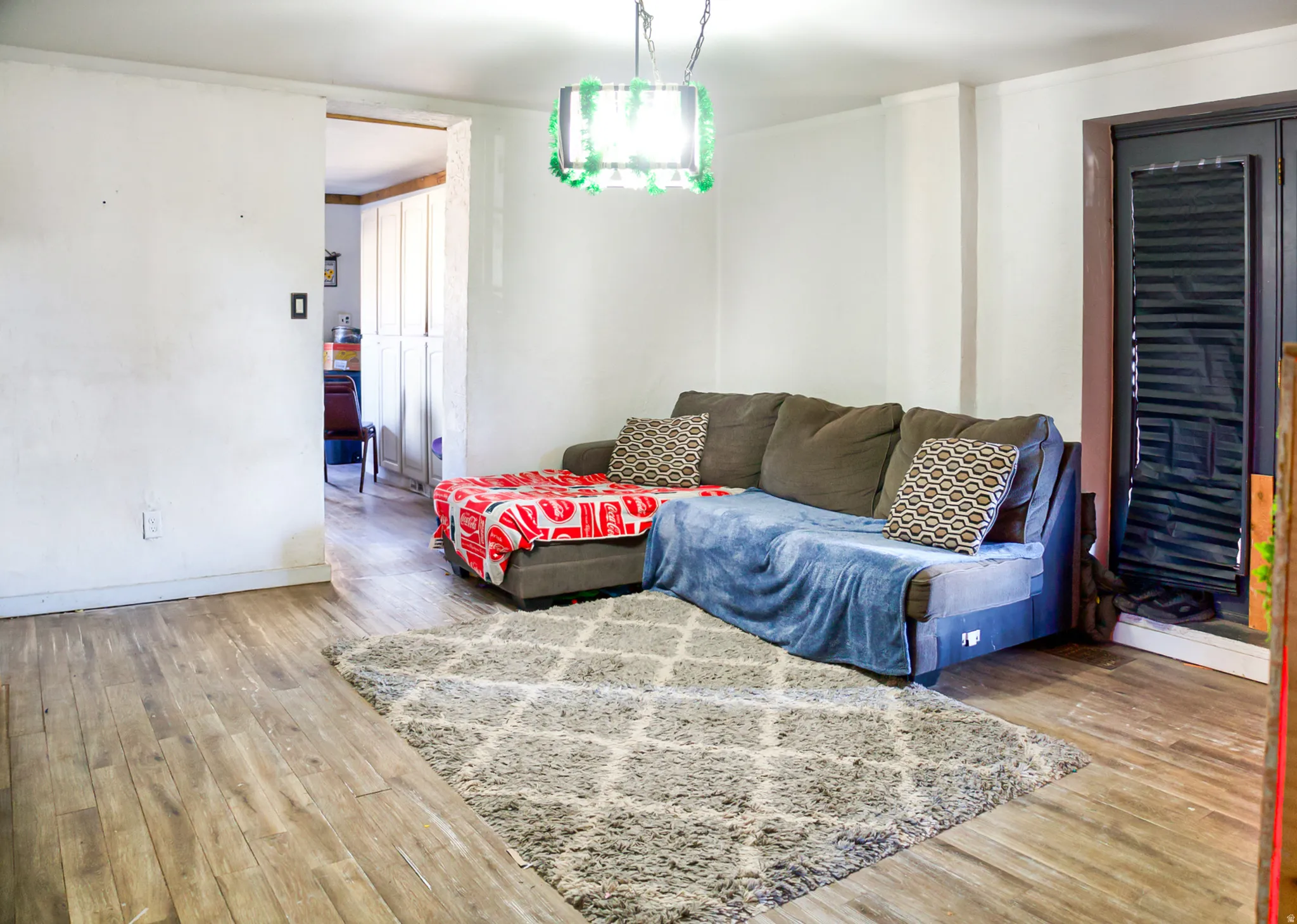 Room featuring wood-finish flooring and white walls