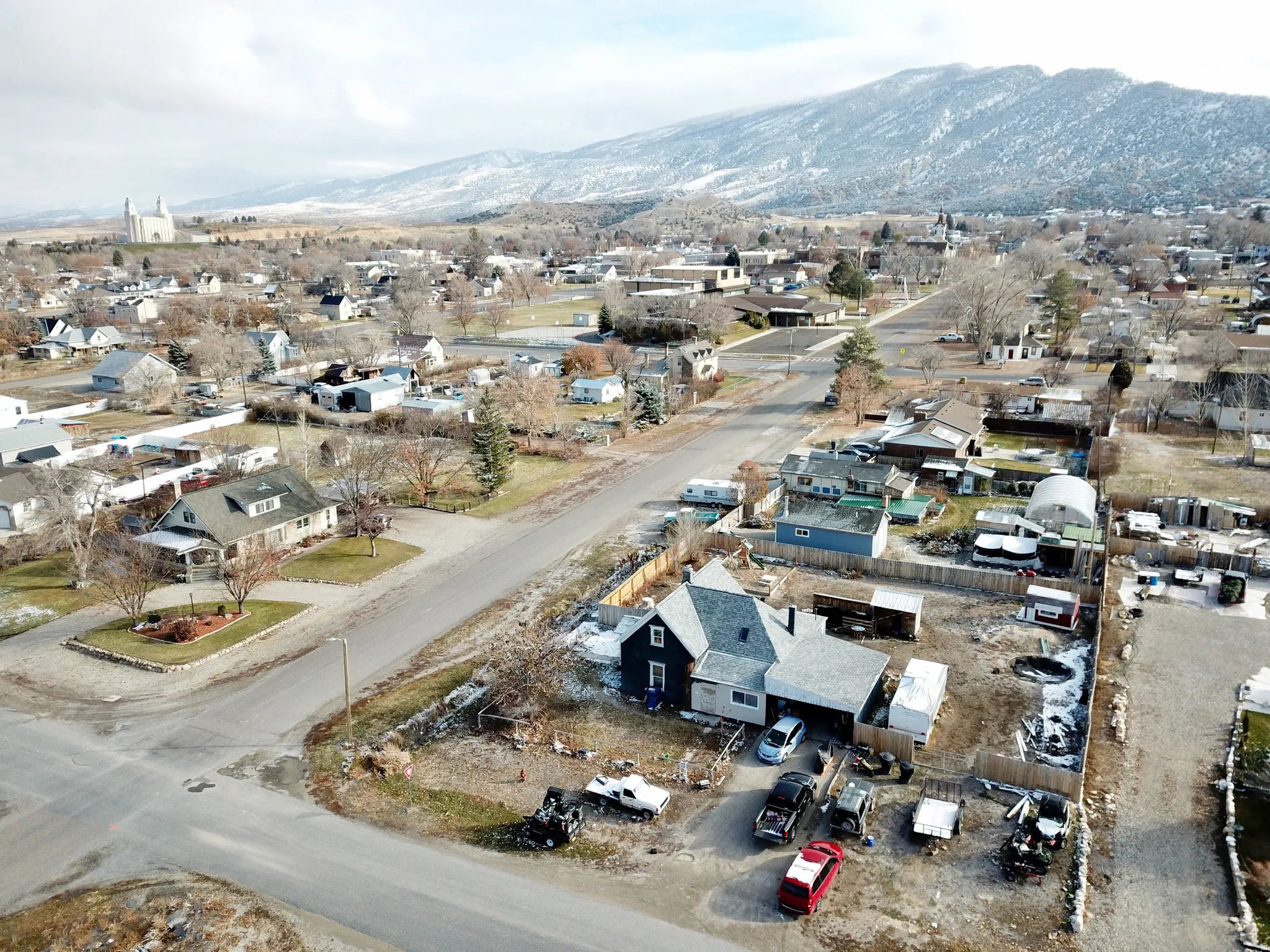 Residential properties situated in a neighborhood with visible mountain scenery