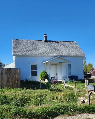 White exterior with a covered porch entry