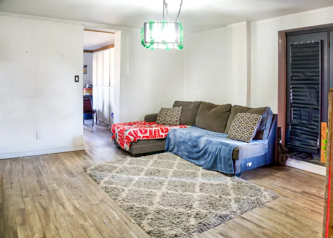 Room featuring wood-finish flooring and white walls