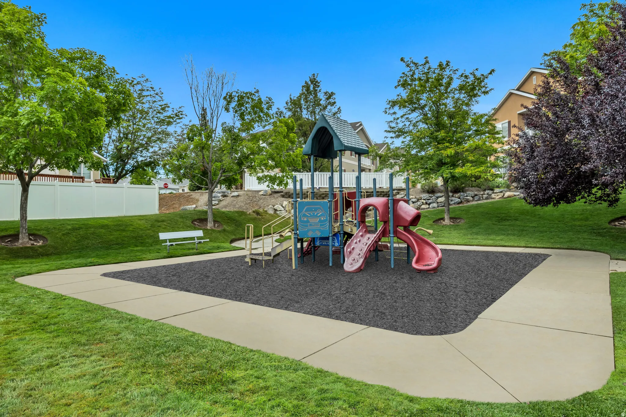 Community playground with multi-level play equipment and multiple slides.