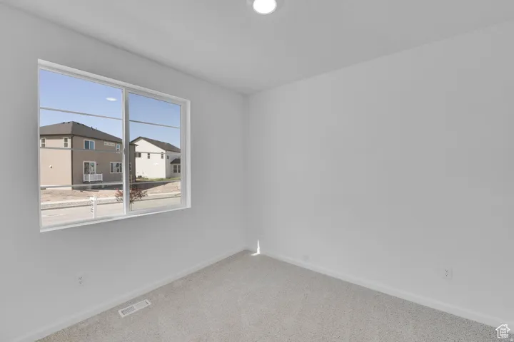Single-pane window featuring white trim and a view of neighboring properties