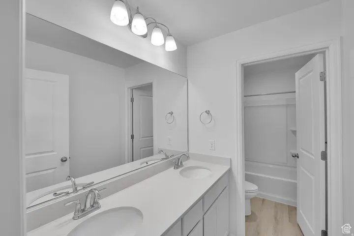 Dual vanity with undermount sinks and chrome fixtures, set against a full-width mirror