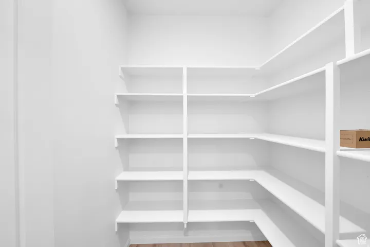 Spacious pantry featuring extensive white shelving