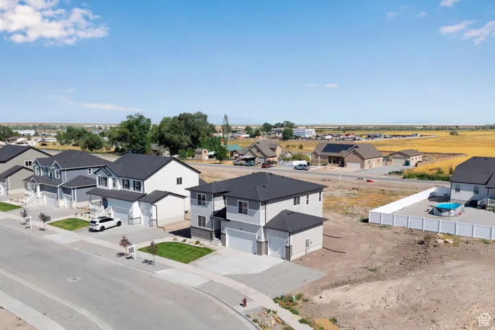 Newly constructed residence featuring a two-story design, an attached garage, and a concrete driveway