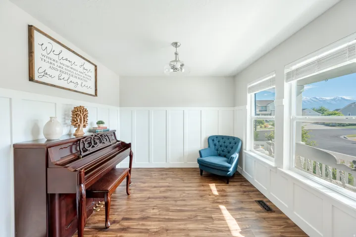 Board and batten wainscoting, wood-finish flooring, multiple windows, recessed lighting, and a ceiling-mounted light fixture