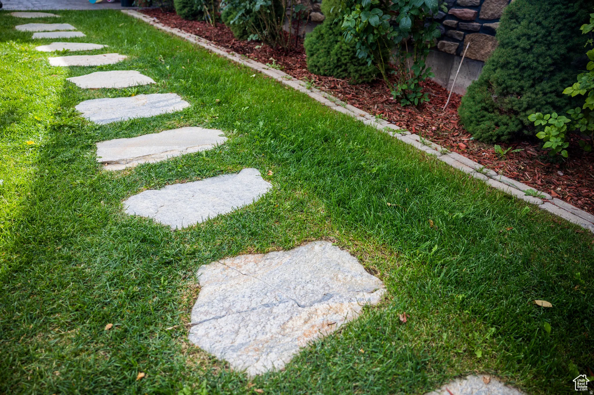 Stone stepping path set in green lawn