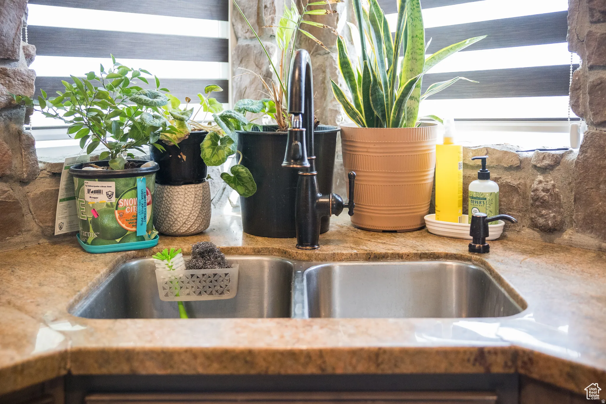 Stainless steel double basin sink with an oil-rubbed bronze gooseneck faucet