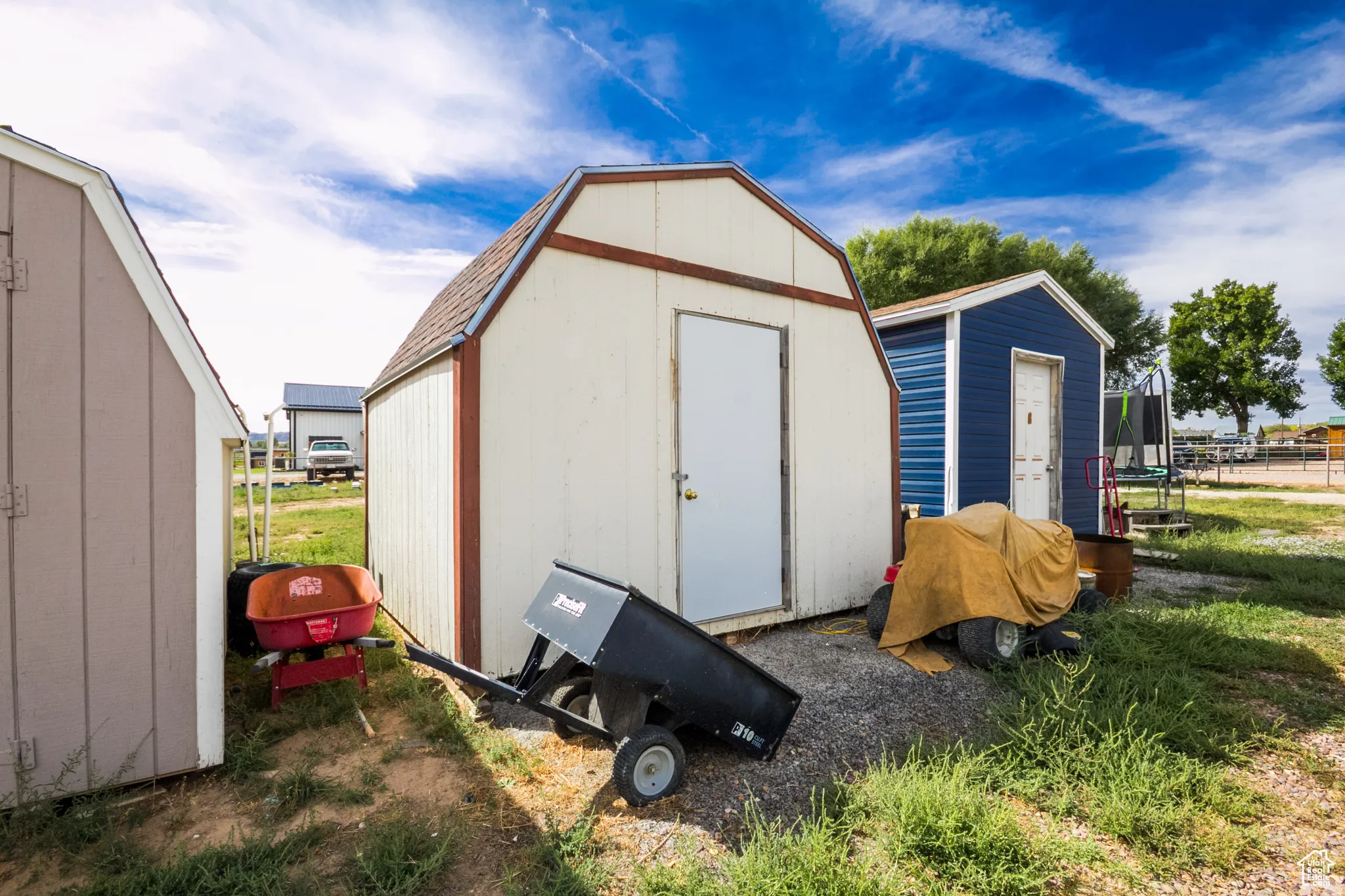 Three storage sheds featuring durable siding and pitched roofs