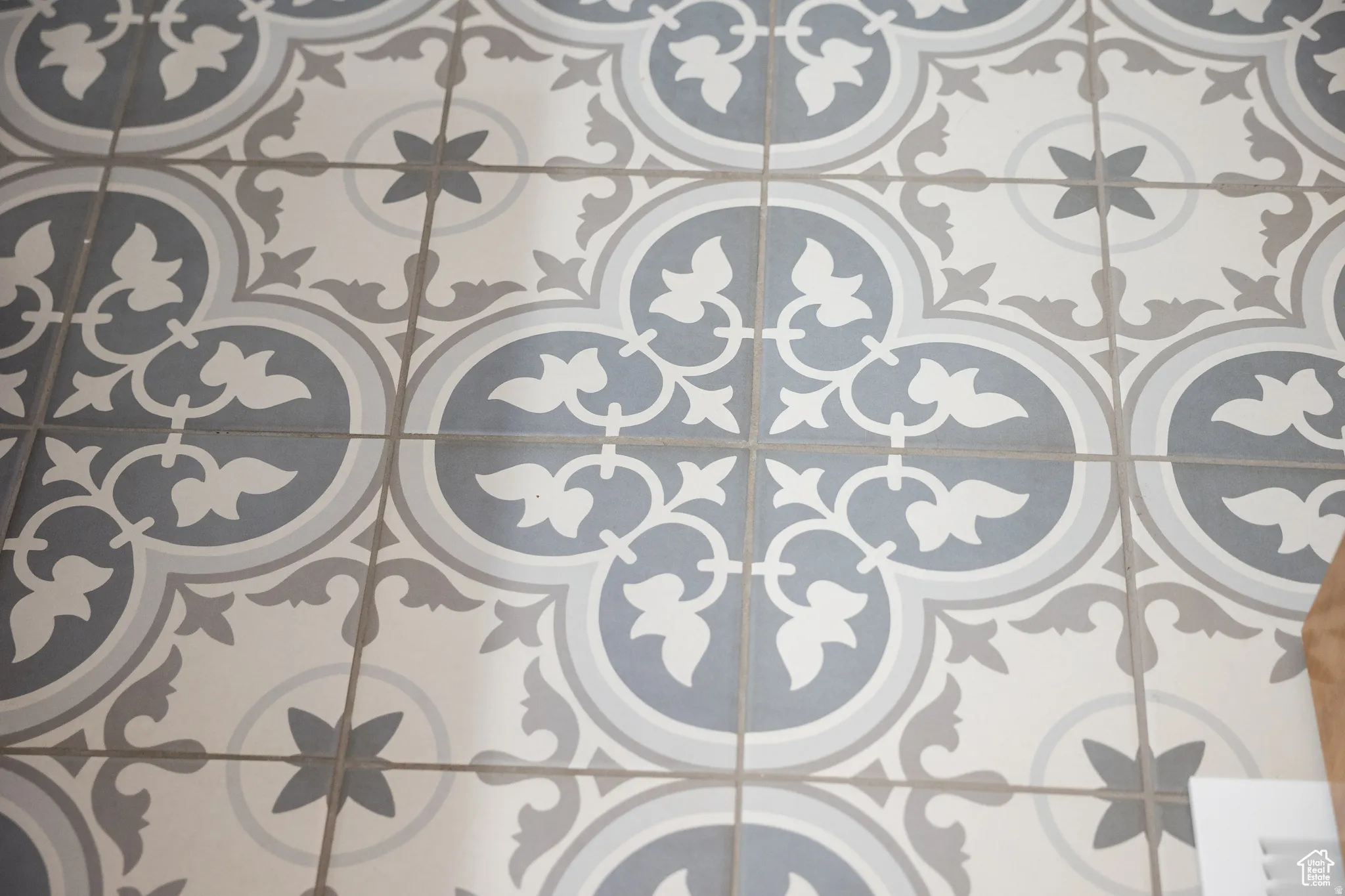 Patterned tile flooring in a gray, white, and light blue palette