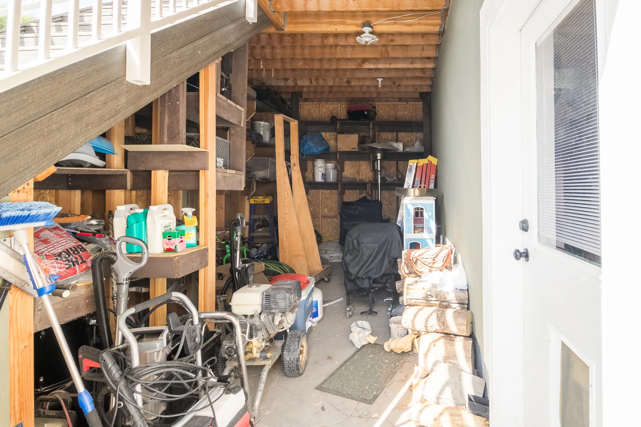 Outdoor storage area featuring a concrete slab and wooden support beams