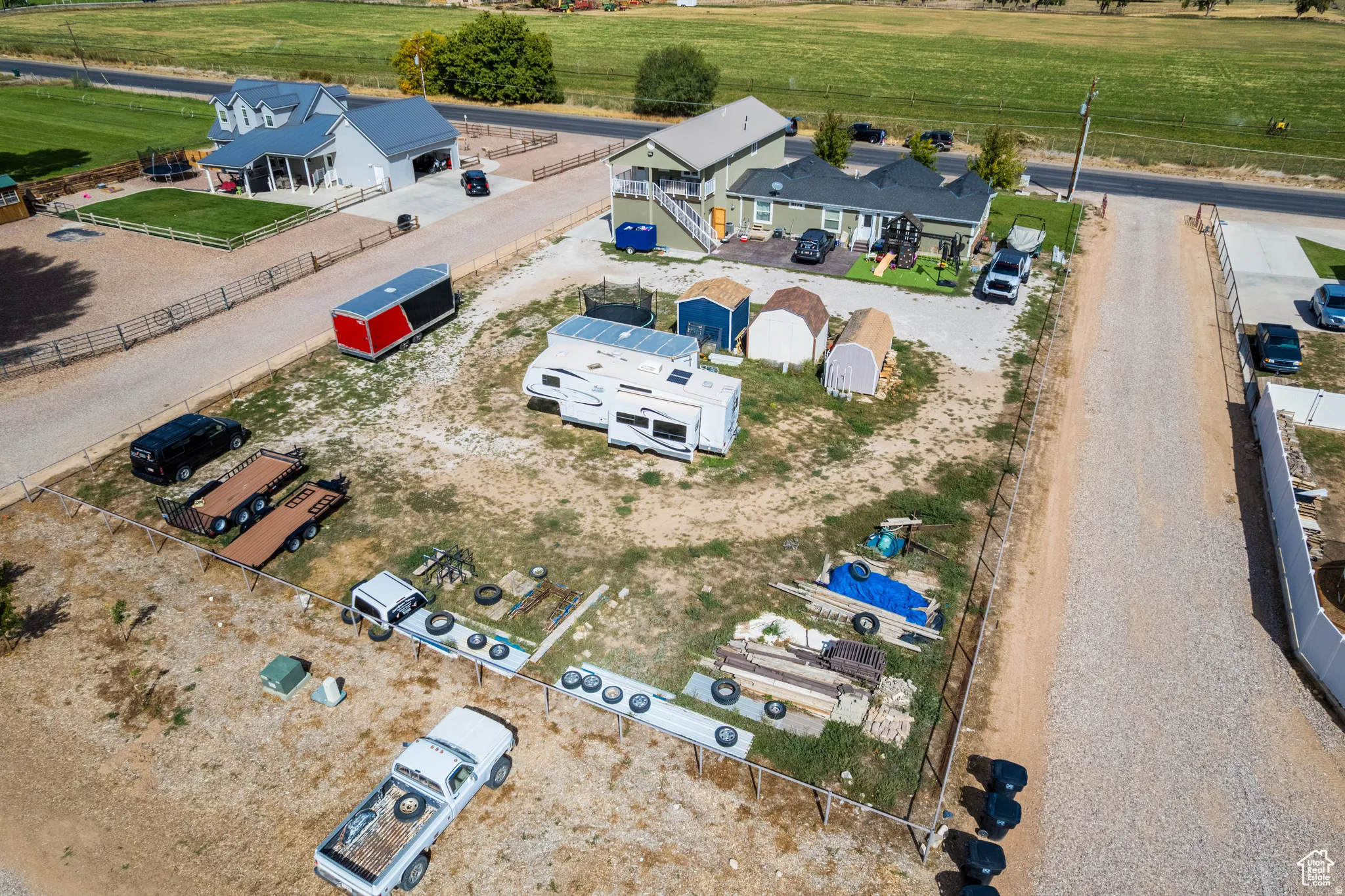 Gravel driveways providing access to multiple buildings and expansive open areas