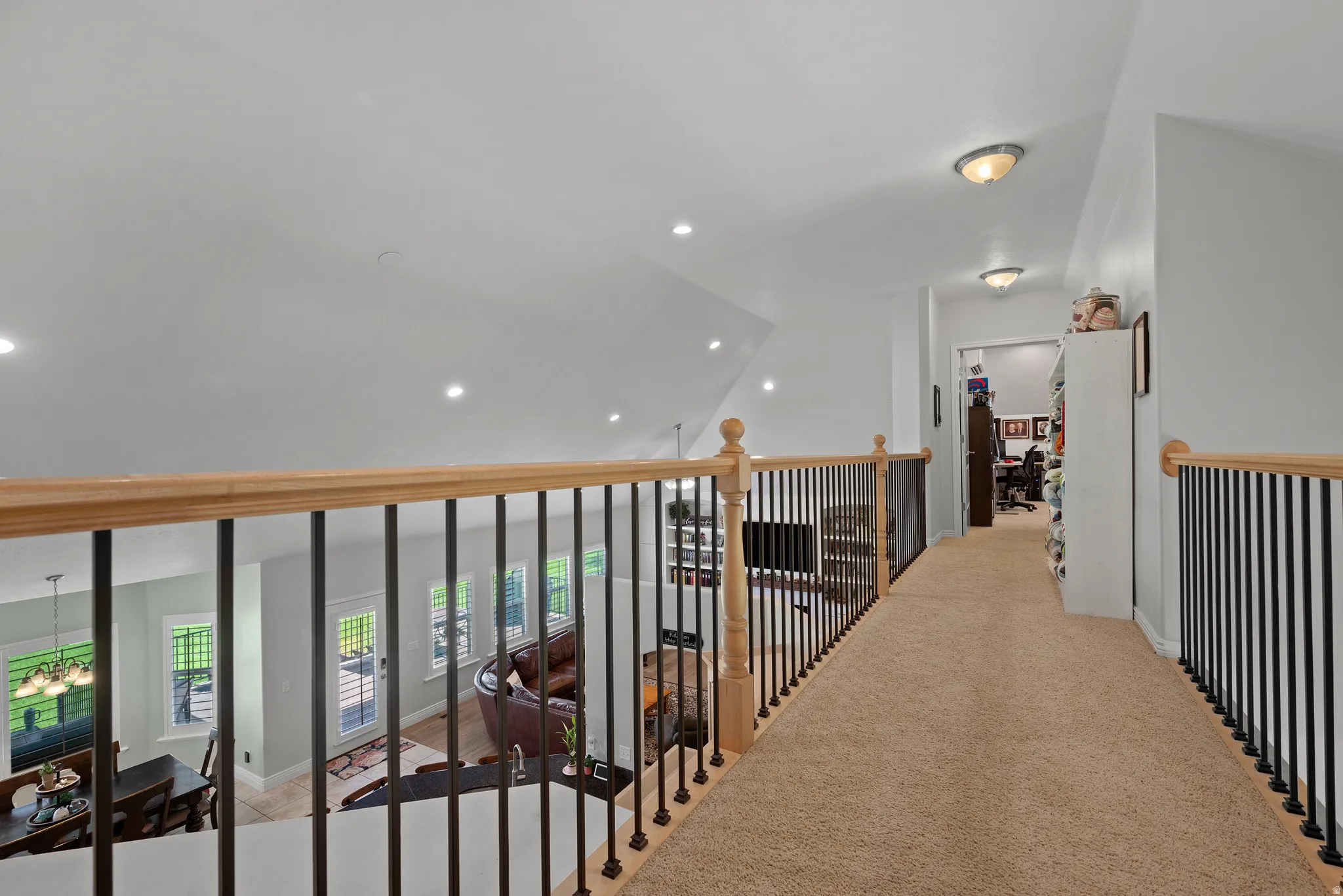Upper-level hallway featuring neutral-toned carpeting, light-toned walls, and recessed lighting