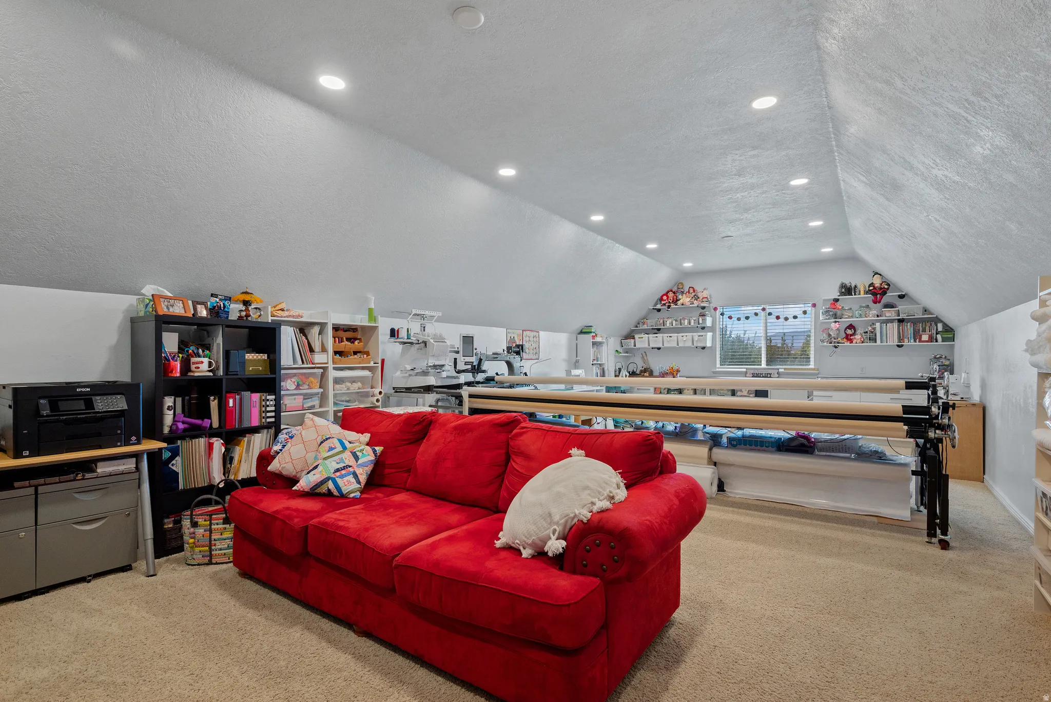 Versatile bonus room featuring vaulted ceilings and recessed lighting