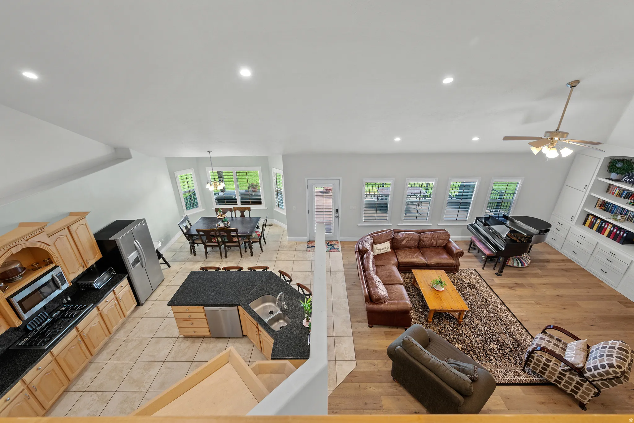 Open-concept living space featuring wood-finish flooring, recessed lighting, and built-in shelving