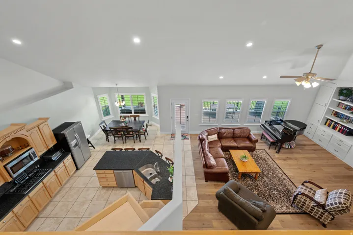 Open-concept living space featuring wood-finish flooring, recessed lighting, and built-in shelving