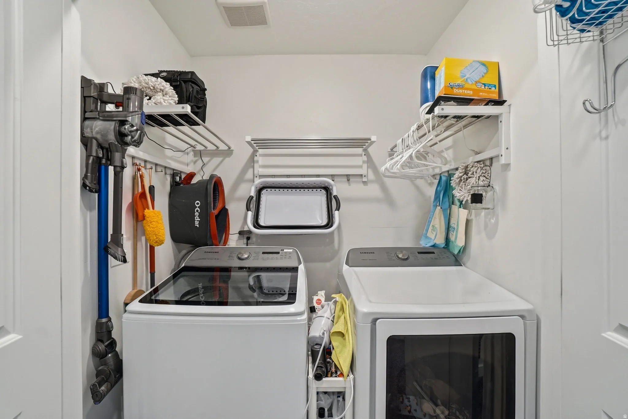 Dedicated laundry area featuring a top-load washing machine and a front-load dryer