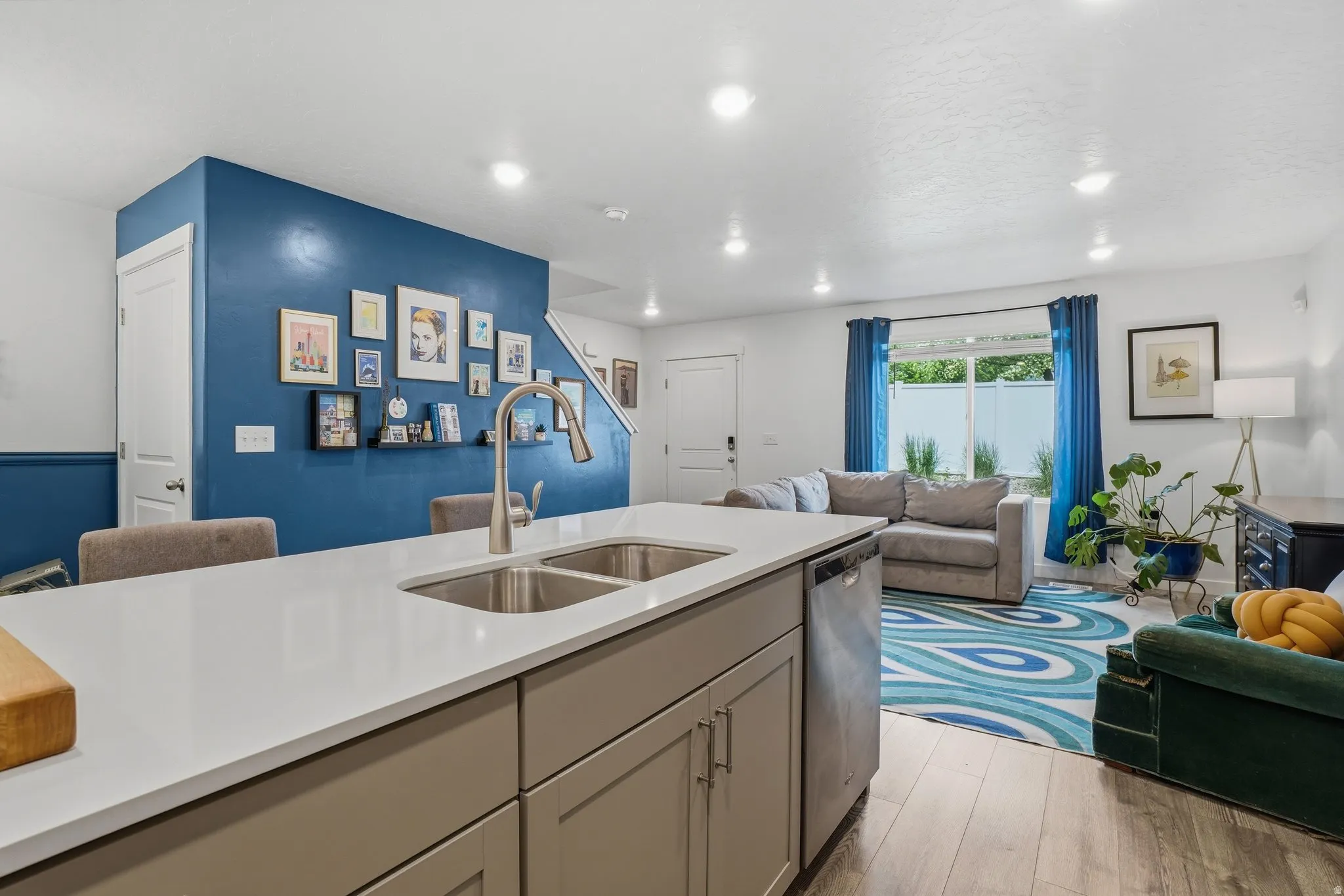 Kitchen island featuring a double-basin stainless steel sink and a gooseneck faucet