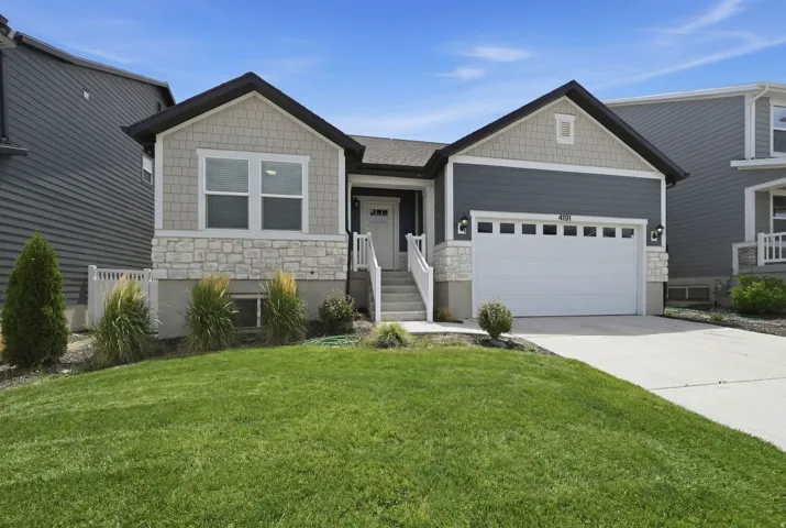 Contemporary exterior featuring stone accents, horizontal siding, and shake siding