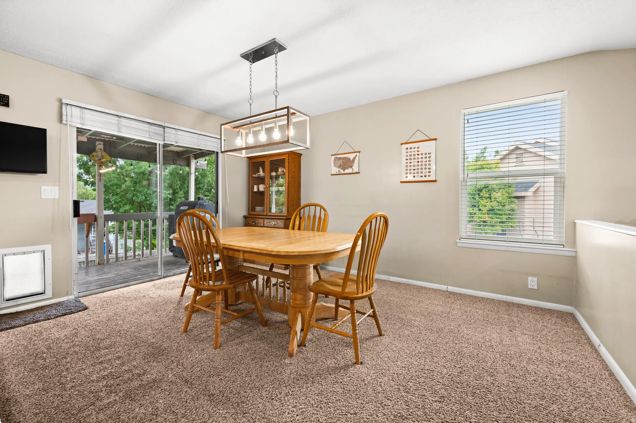 Carpeted interior with neutral wall tones and a window offering natural light