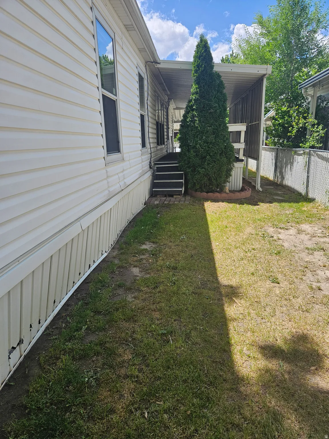 White vinyl siding exterior with multiple windows