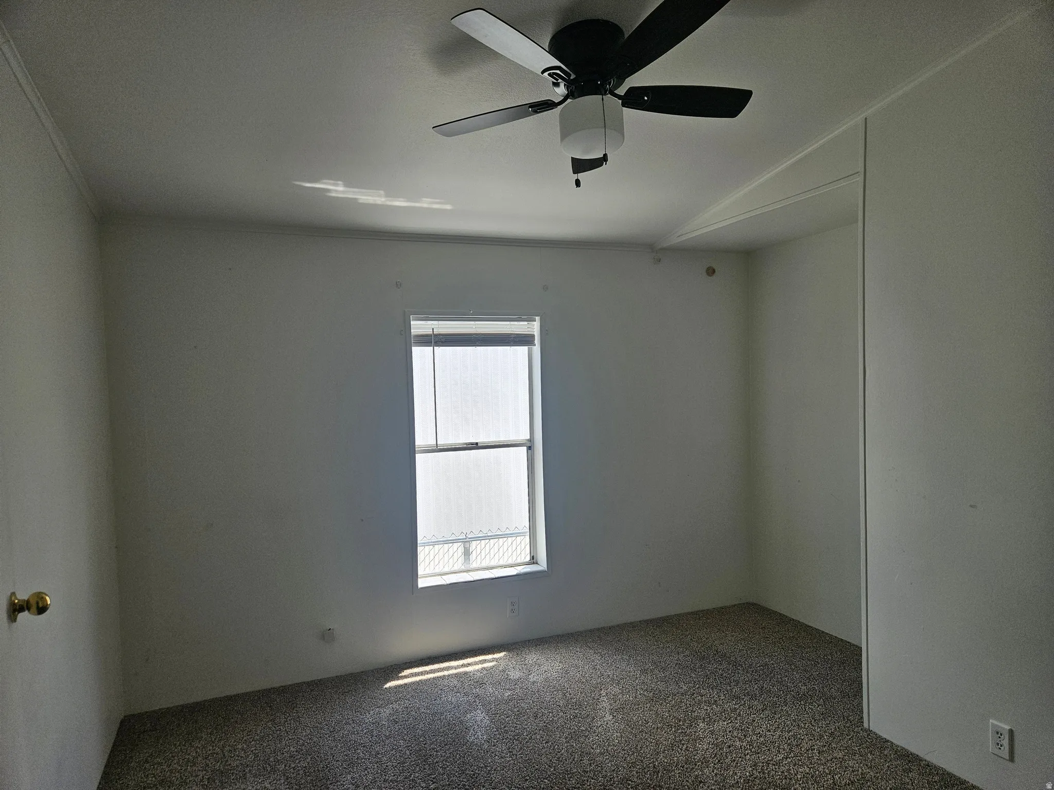 Room featuring neutral wall tones and textured carpeting