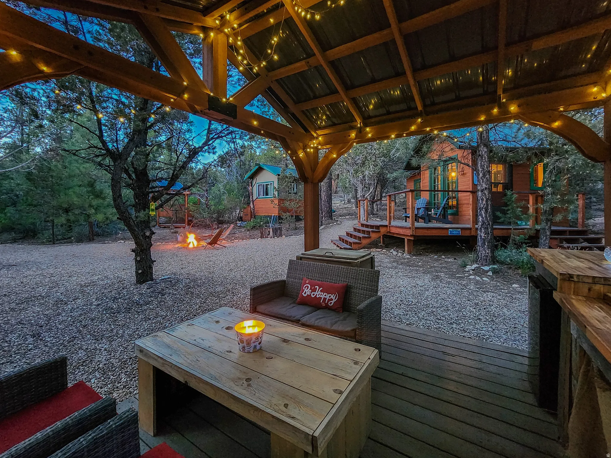 Covered wood-deck patio with exposed timber beams and string lighting