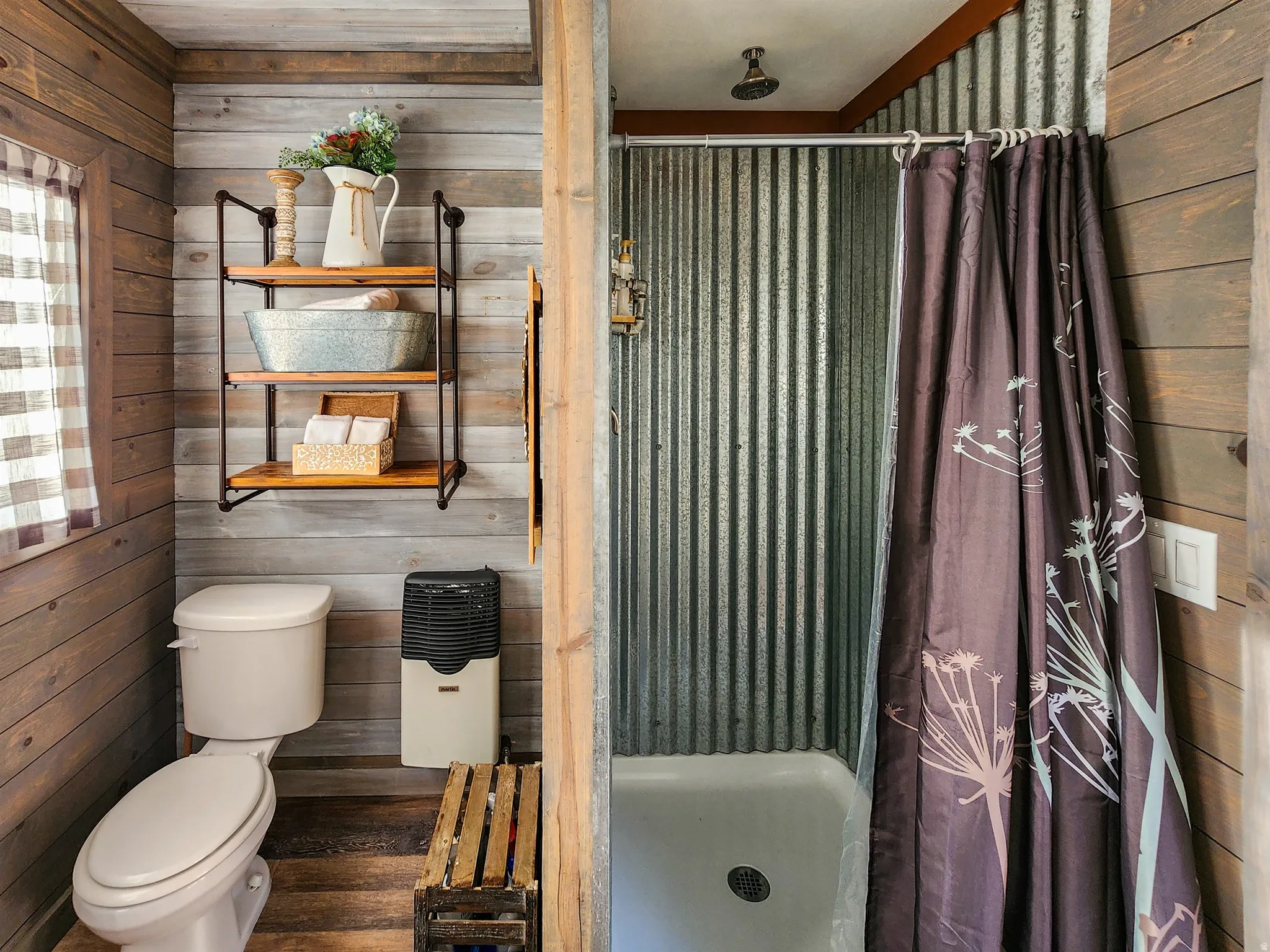 Bathroom featuring horizontal wood-finish wall paneling and a shower with corrugated metal walls