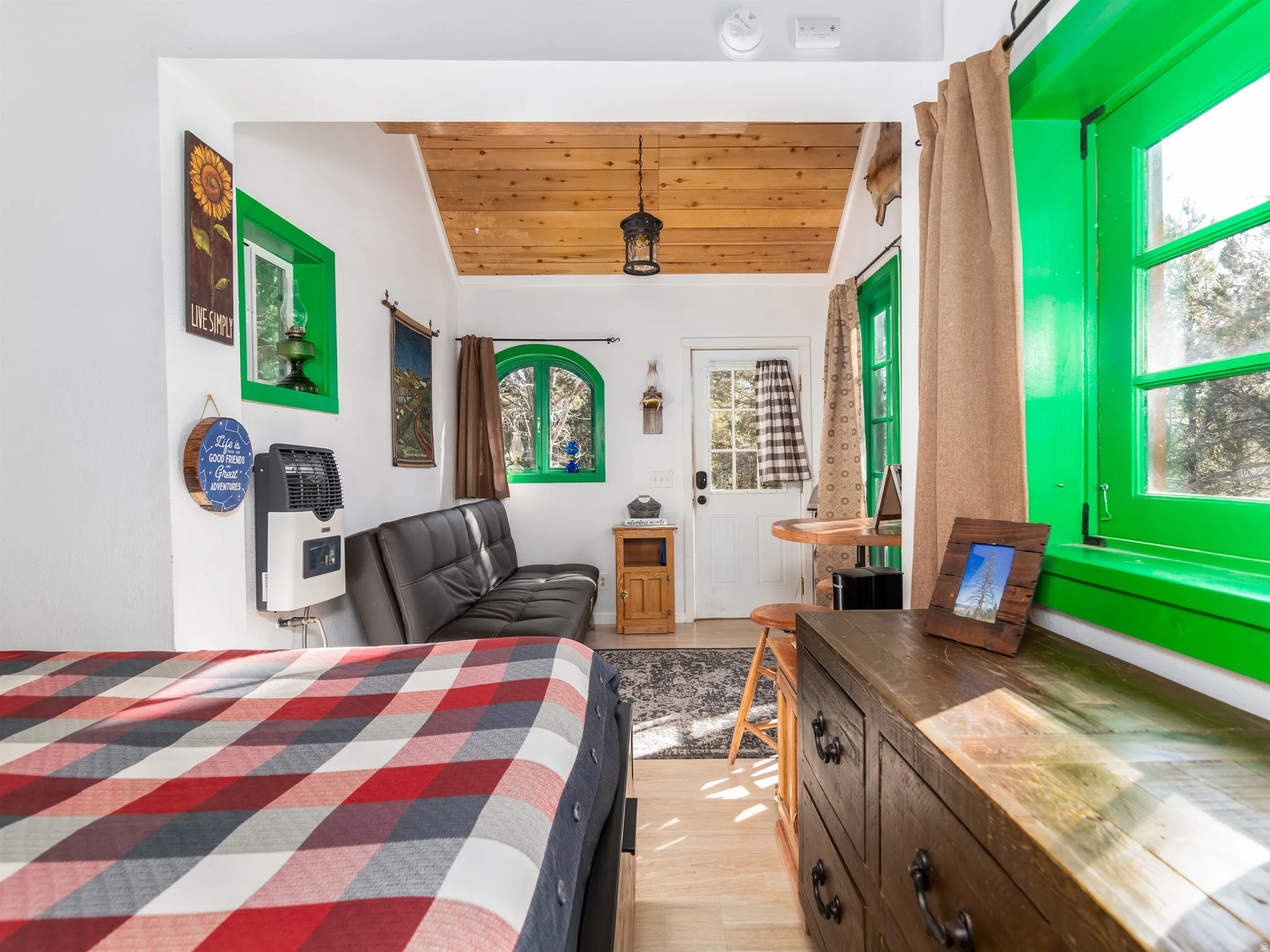 Interior space featuring a wood-finish ceiling, light wood-finish flooring, and white walls